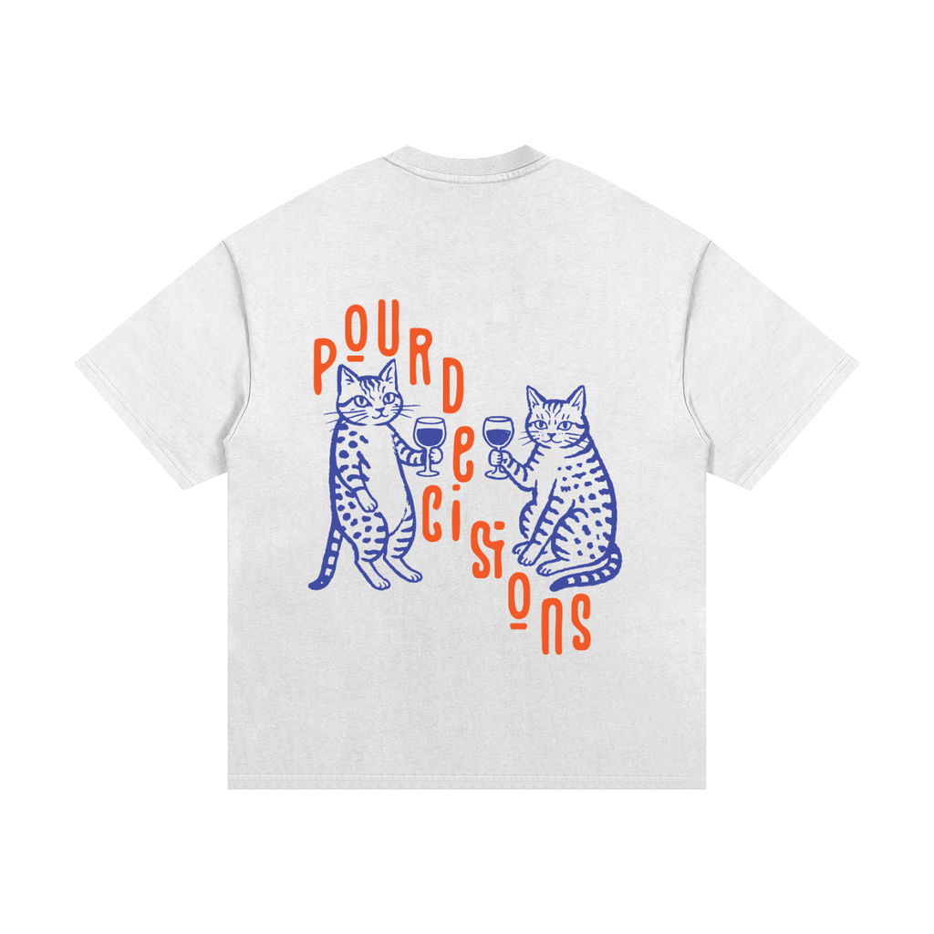 A white short-sleeve t-shirt shown from the back, featuring a graphic print of two blue spotted cats holding wine glasses with orange text reading 'POUR deicision'.