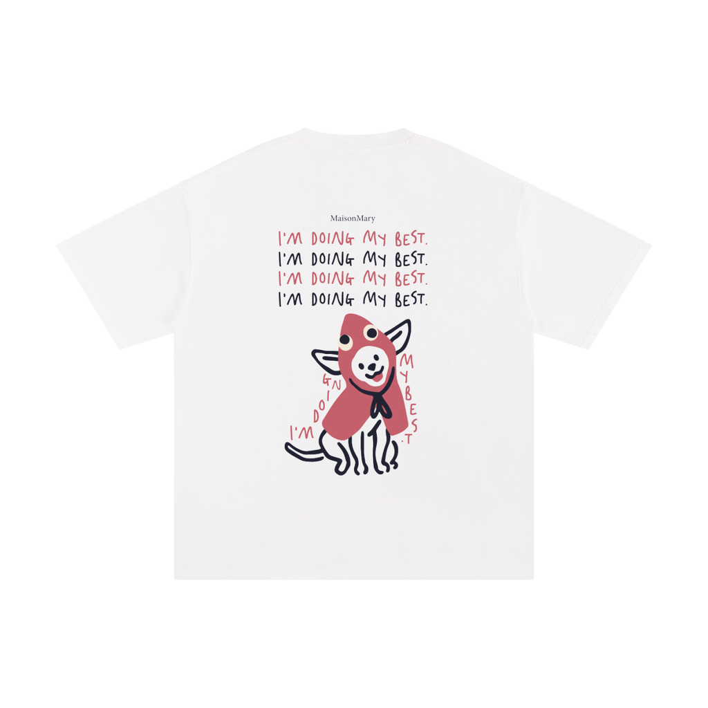 A white short-sleeve t-shirt featuring a graphic print of a cartoon dog wearing a red sweater, with the text 'I'm Doing My Best.' repeated in red and black.