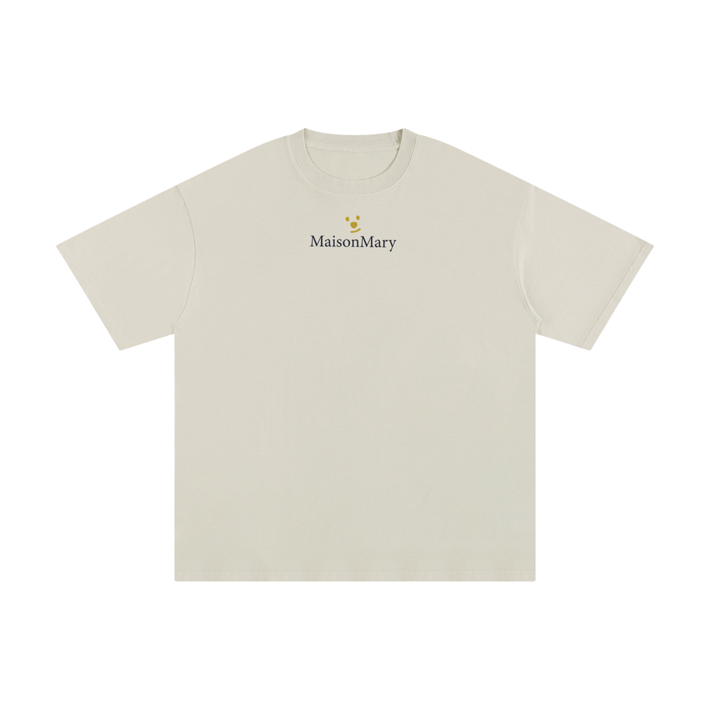 A light beige short-sleeve crewneck t-shirt with a small MaisonMary logo printed in black on the center chest, accompanied by a tiny yellow flower graphic. 