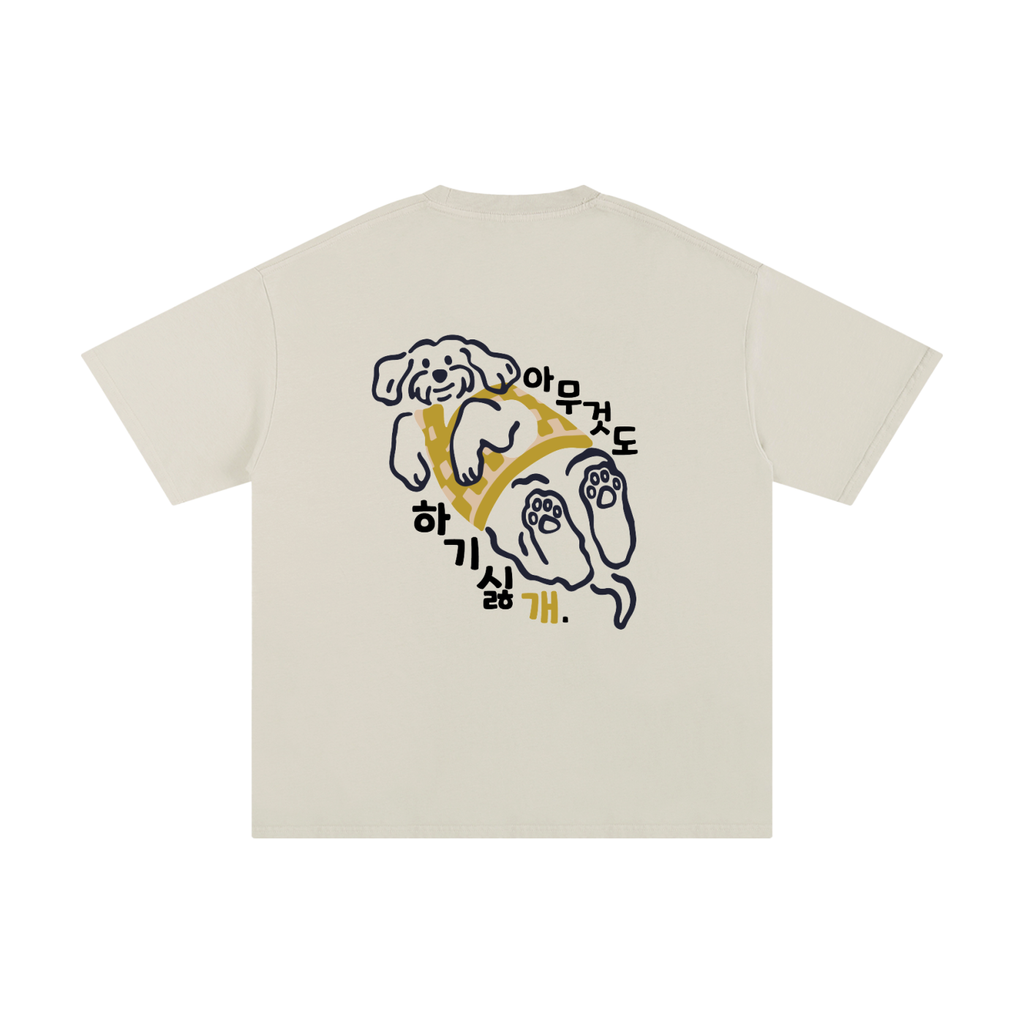 An off-white short-sleeve t-shirt with a graphic print on the back. The graphic features black line drawings of three dogs, a gold V-shaped path, and Korean text in black and gold.