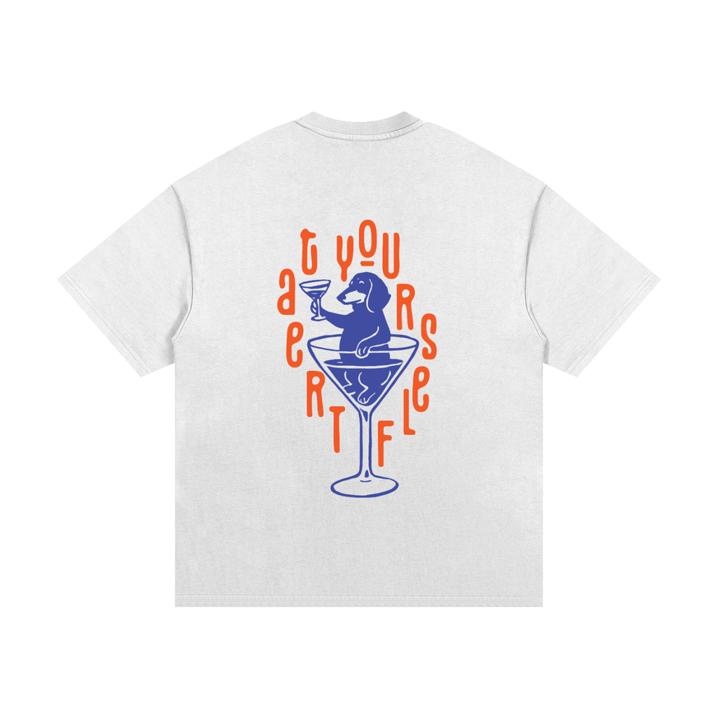 A white short-sleeve t-shirt shown from the back, featuring a graphic print of a blue dachshund sitting in a martini glass surrounded by orange text that reads TREATYOURSELF