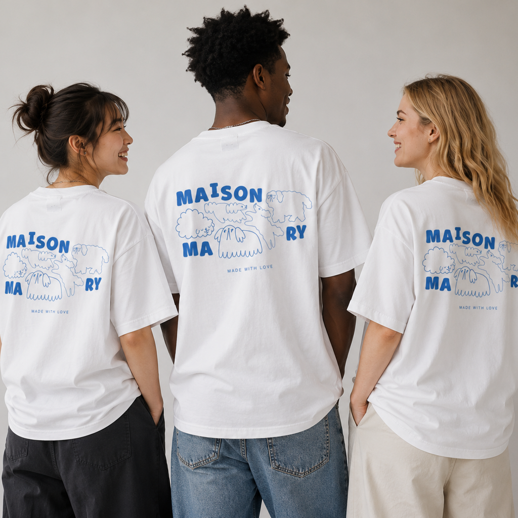 Three models shown from the back wearing white t-shirts with a blue graphic print on the back. The graphic features the text 'MAISON MAONY' and a line drawing of dogs
