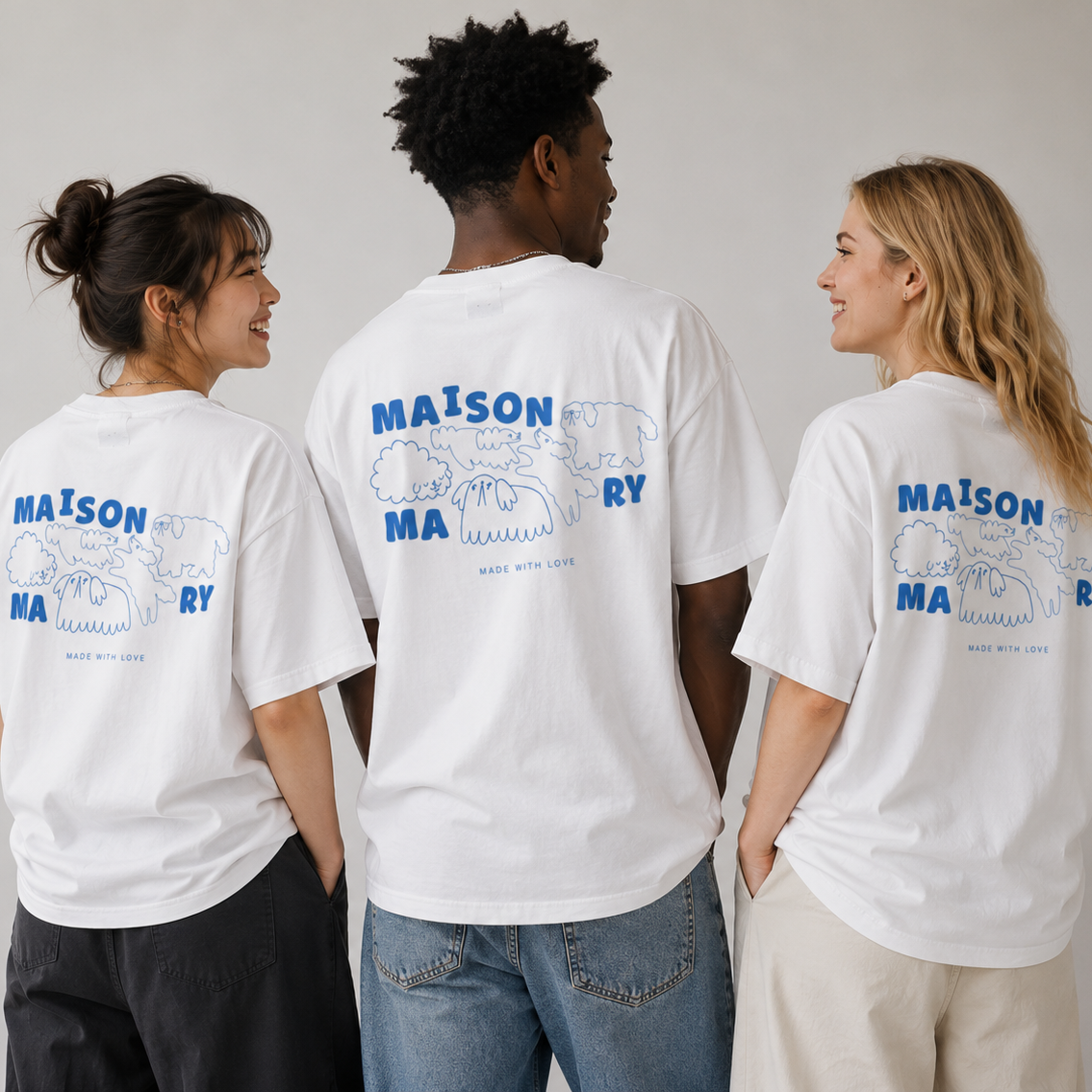 Three models shown from the back wearing white t-shirts with a blue graphic print on the back. The graphic features the text 'MAISON MAONY' and a line drawing of dogs